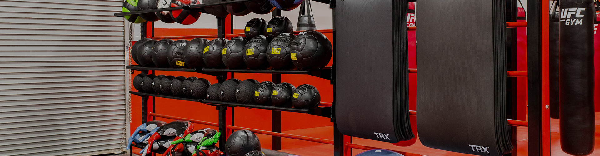 black and red workout equipment on gym racks