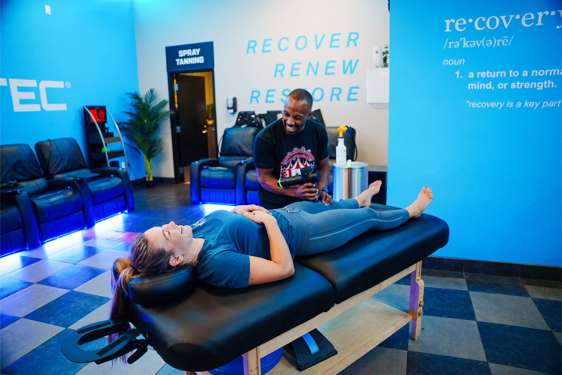 photo of two women using black massage chairs
