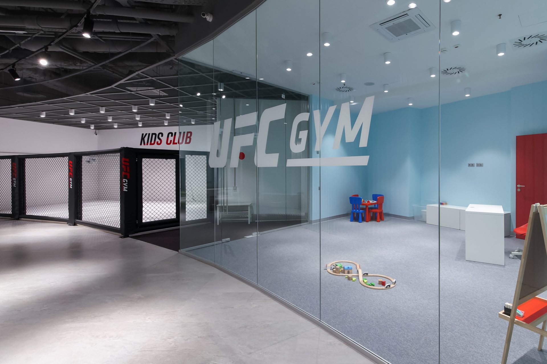 photo of UFC gym with blue and glass walls and kid toys