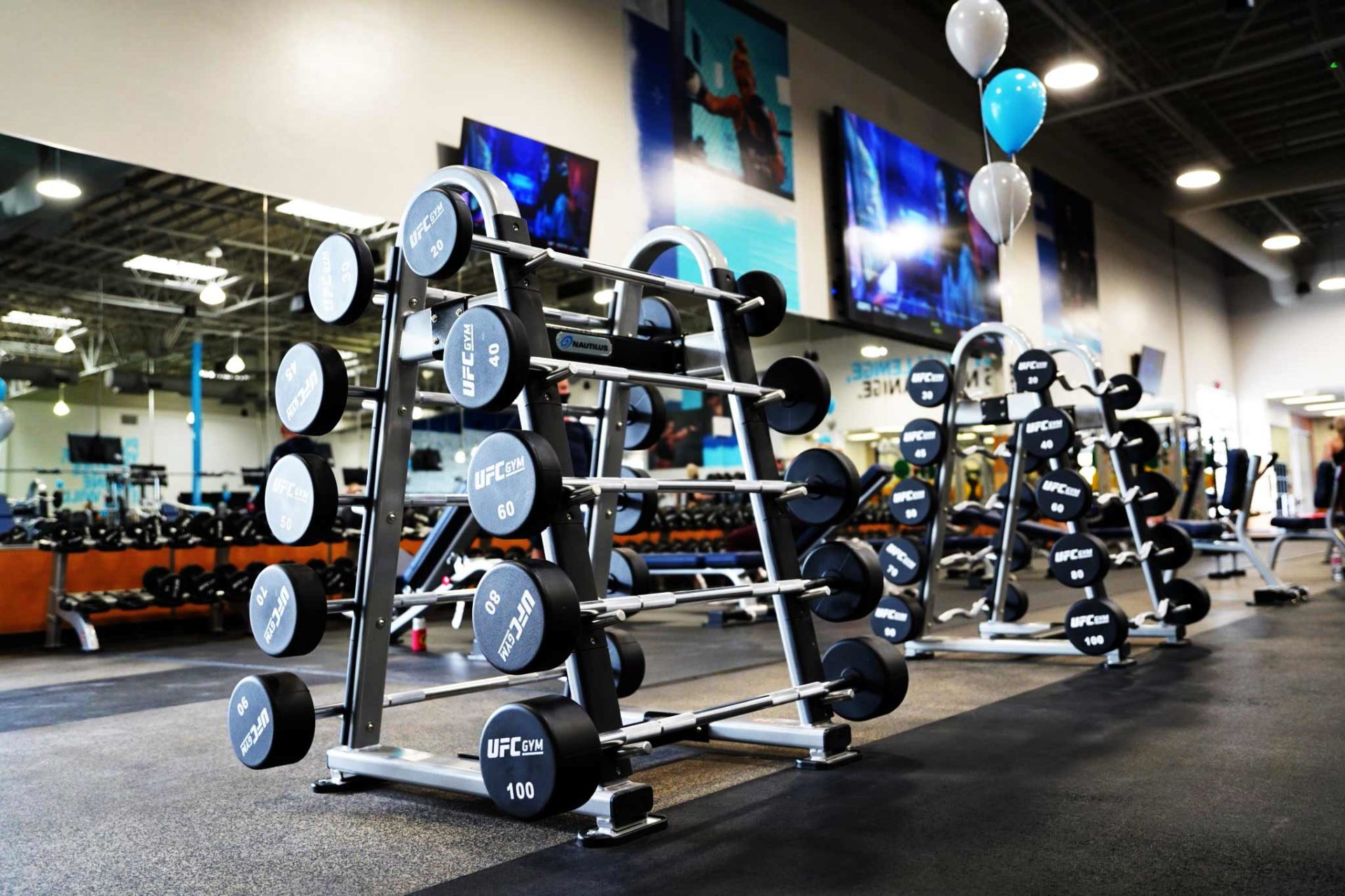 photo of gray and black weight racks in gym