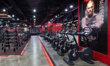 Image of interior UGC GYM with free weights and cycling machines