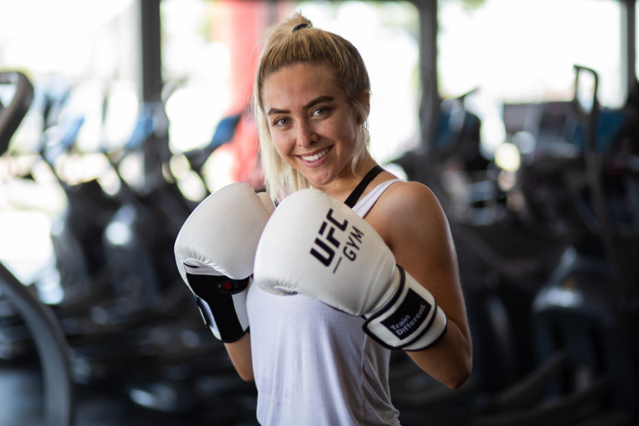 Image of woman wearing white boxing gloves